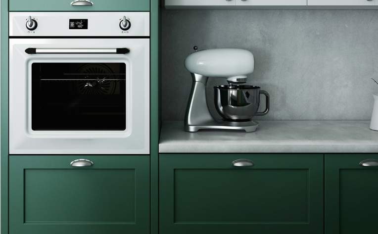 dark green kitchen cabinets in kitchen with stainless steel appliances.